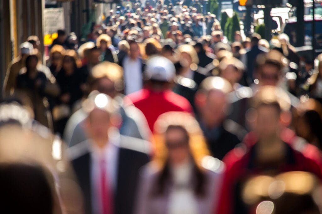 People walking on a high street faces blurred
